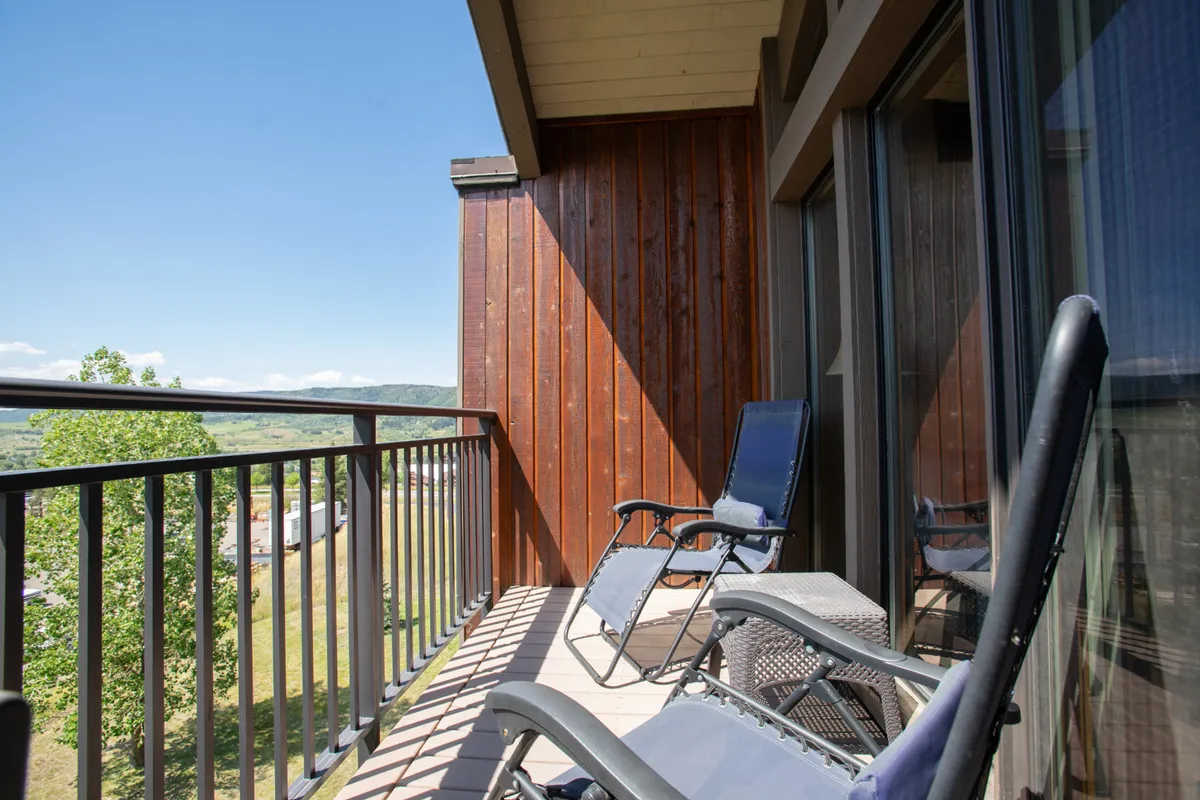 A tranquil balcony scene with lounge chairs overlooking stunning landscape views. The balcony is an inviting spot for relaxing, reading, or enjoying the sunrise or stars in a peaceful outdoor setting.